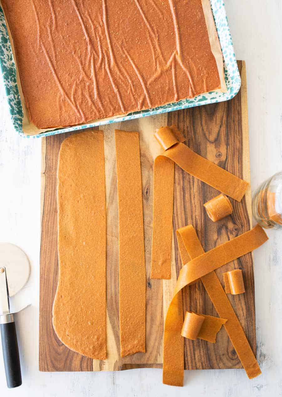 cutting fruit leather on cutting board.