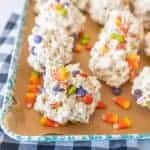 halloween popcorn balls with candy corn on enamel baking sheet