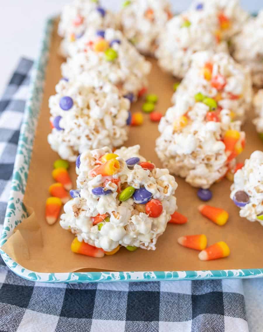 halloween popcorn balls with candy corn on enamel baking sheet