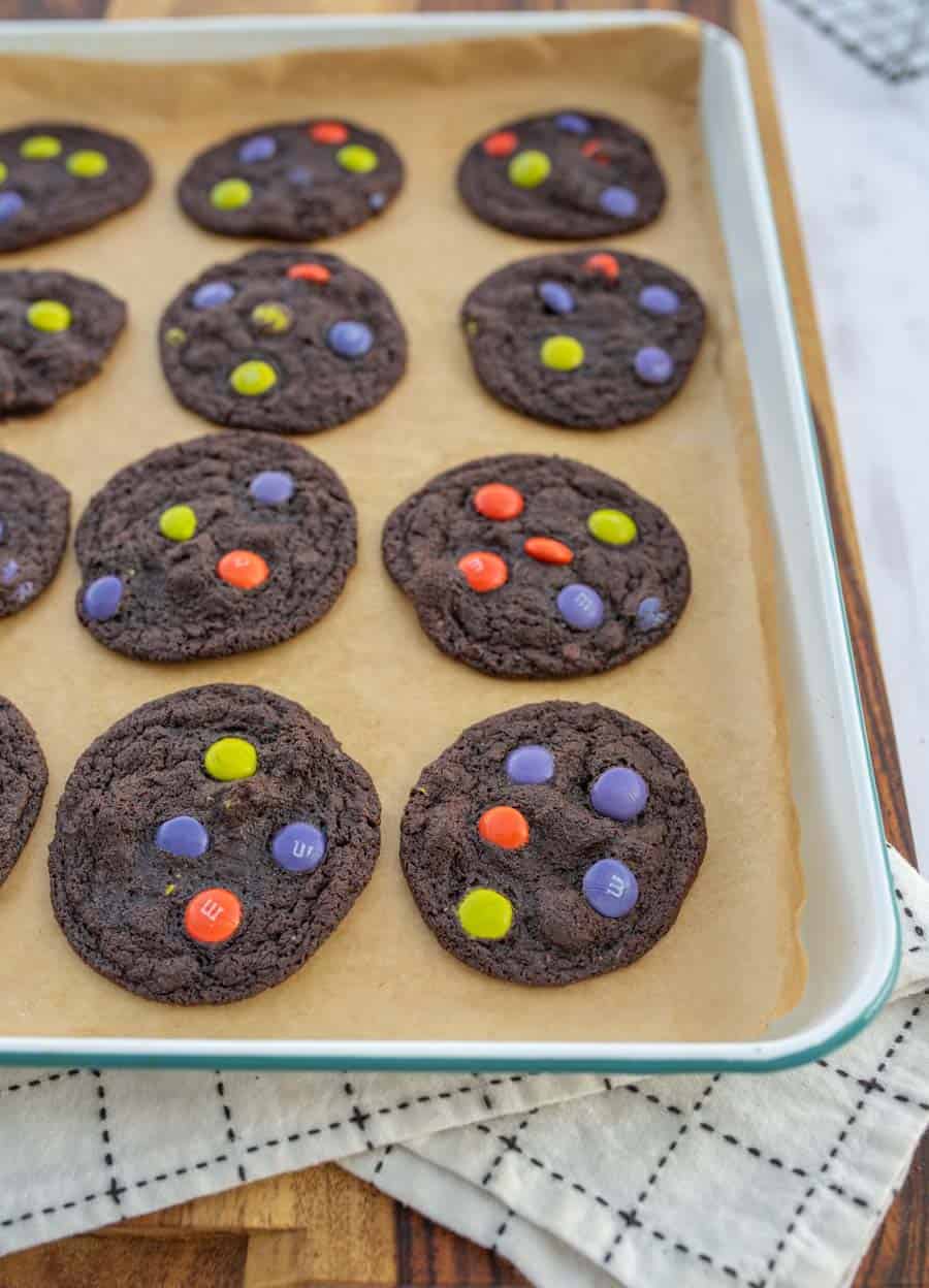 halloween dark chocolate M&M cookies on enamel baking sheet