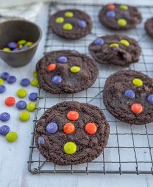 dark chocolate Halloween M&M cookies on cooling rack