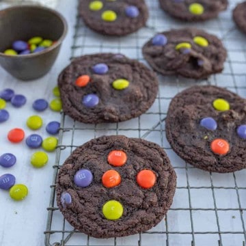 dark chocolate Halloween M&M cookies on cooling rack