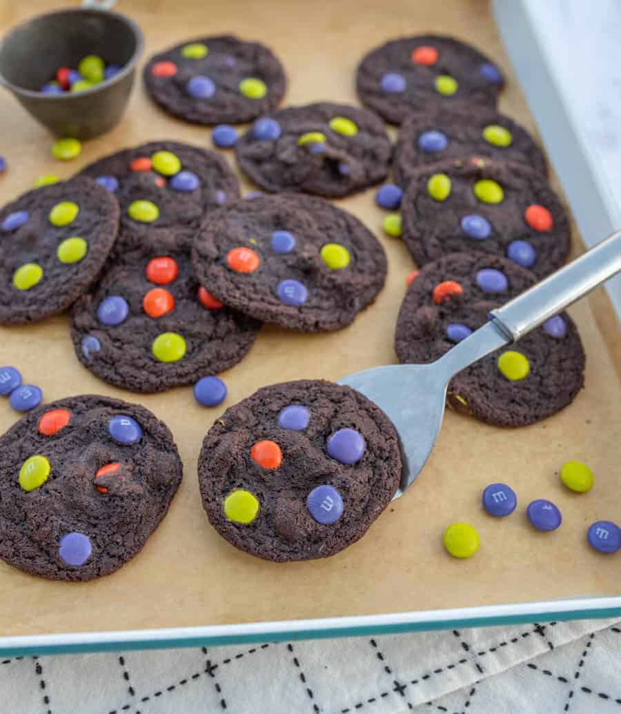 baking sheet filled with dark chocolate halloween M&M cookies