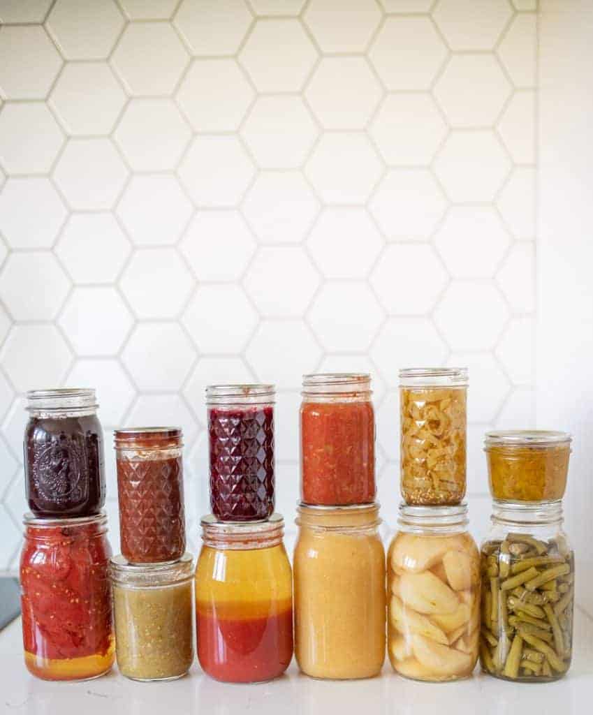 14 jars of various home canned products displayed together
