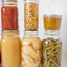 6 jars of various home canned products displayed together