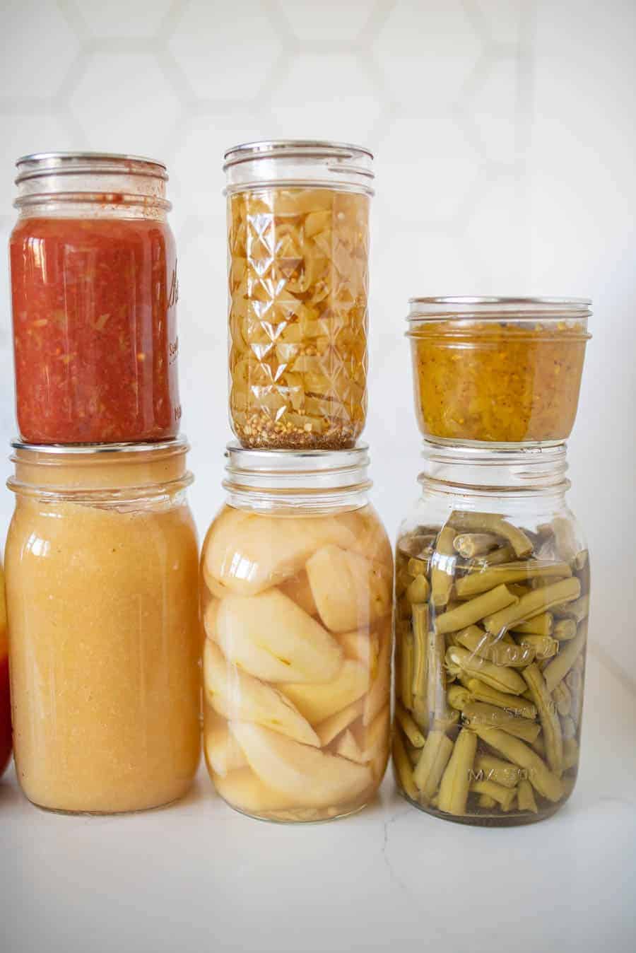 6 jars of various home canned products displayed together