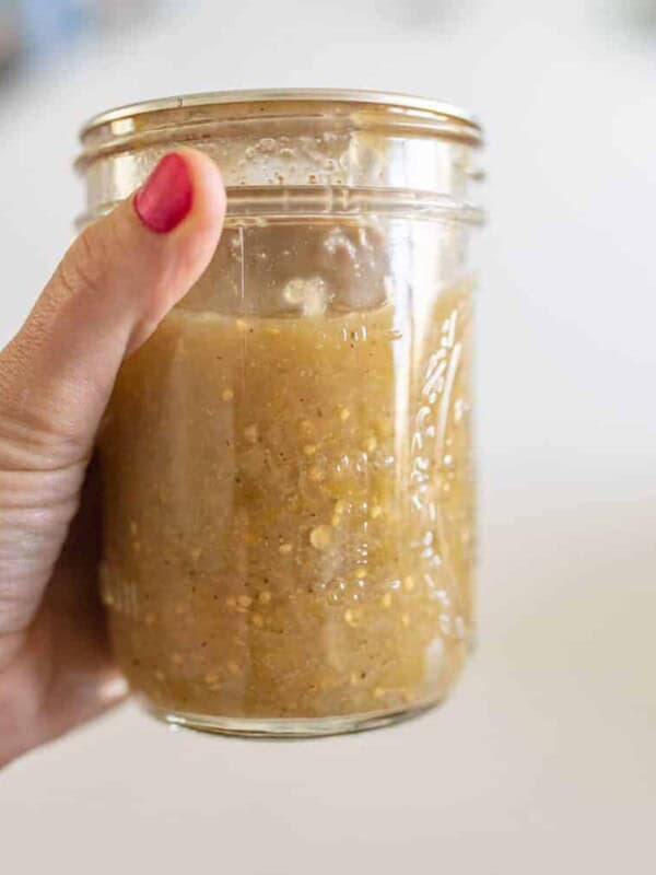 hand holding jar of tomatillo salsa