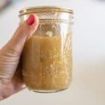 hand holding jar of tomatilla salsa