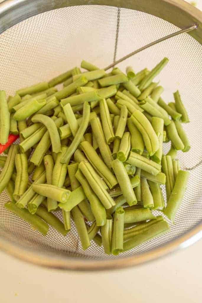 snapped green beans in strainer