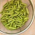 snapped green beans in strainer