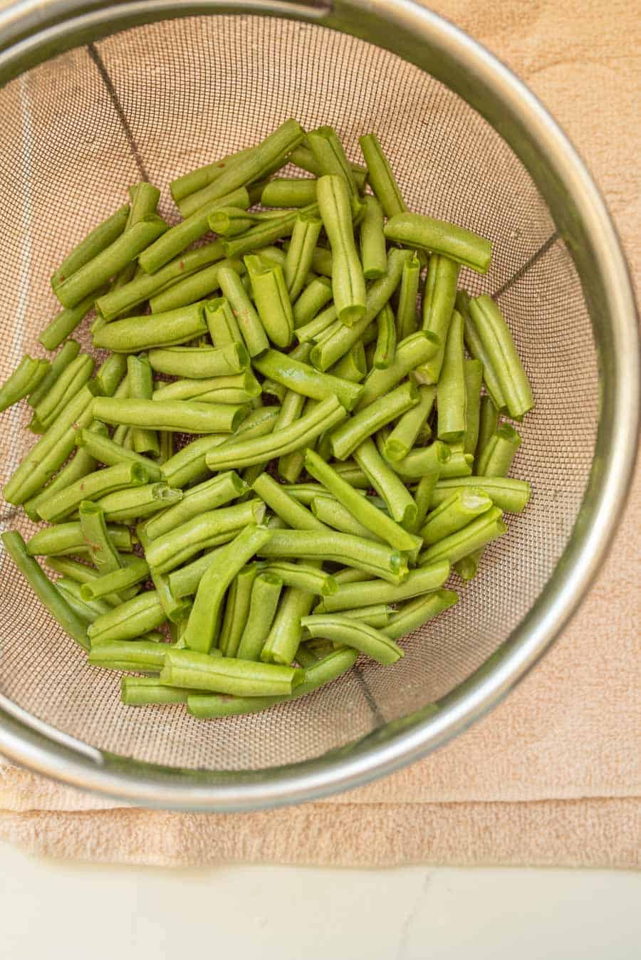 snapped green beans in strainer