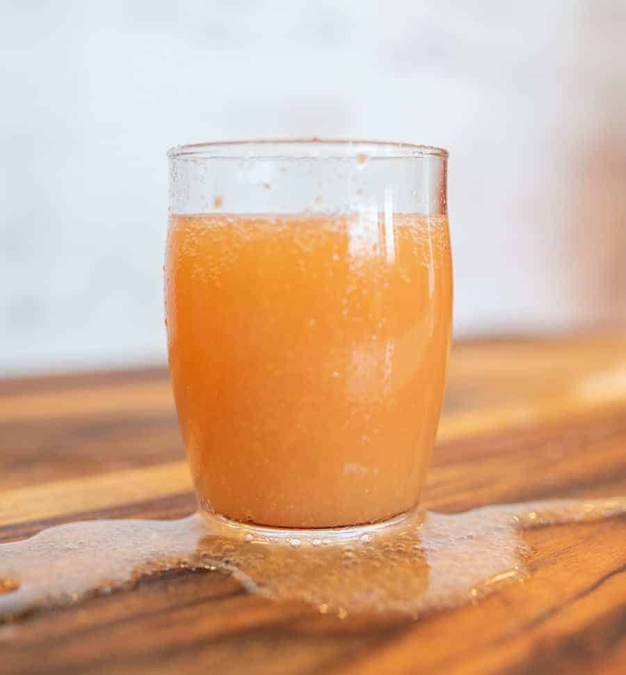 small glass of kombucha showing effervescence