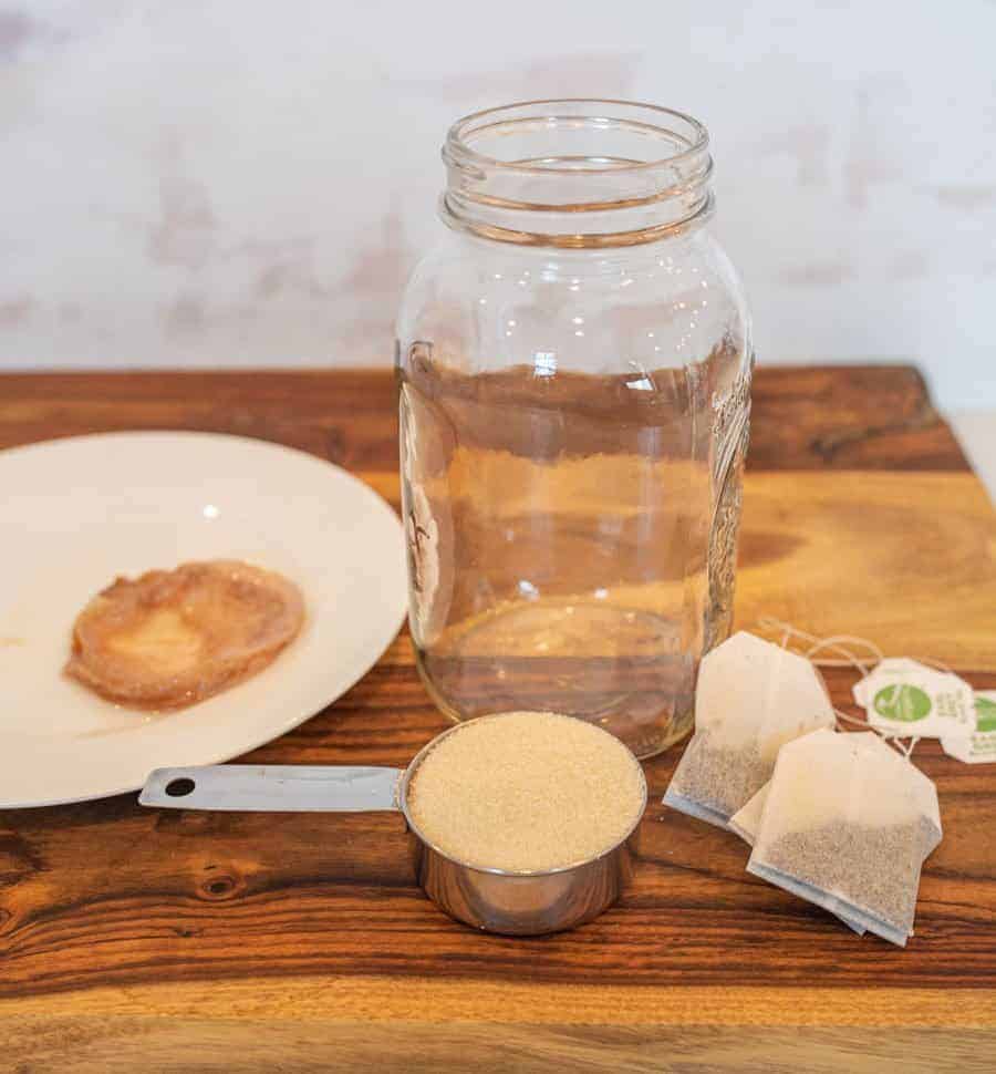 half gallon mason jar, sugar, tea, and scoby