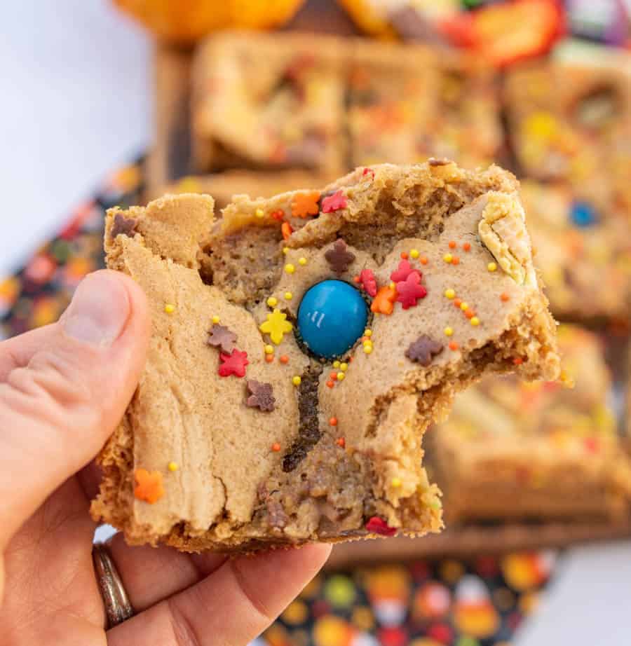 halloween cookie bar held in hand with one bite taken