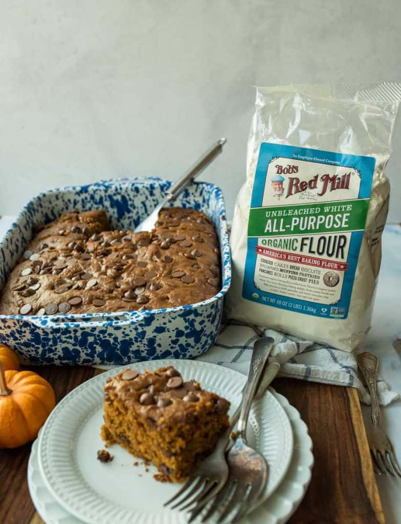pumpkin cake cut into pieces in blue pan