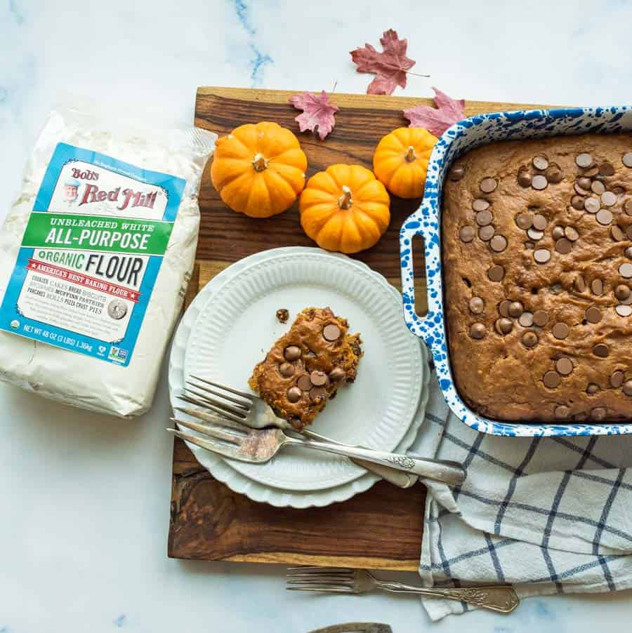 pumpkin cake cut into pieces in blue pan