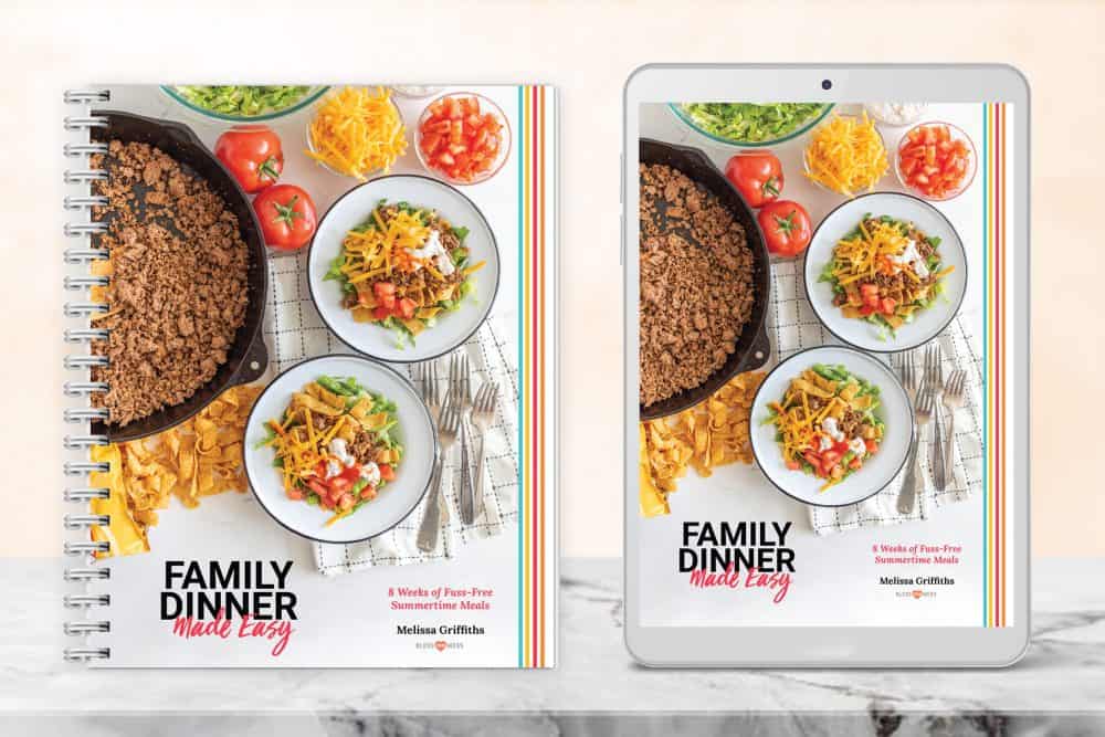 a photo of "family dinner made easy" the digital cookbook cover shown on an iPad screen and a bound book.