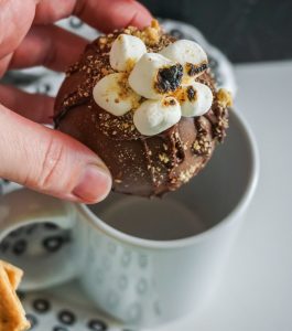 above shot of hot chocolate bomb dropping in to a light blue mug