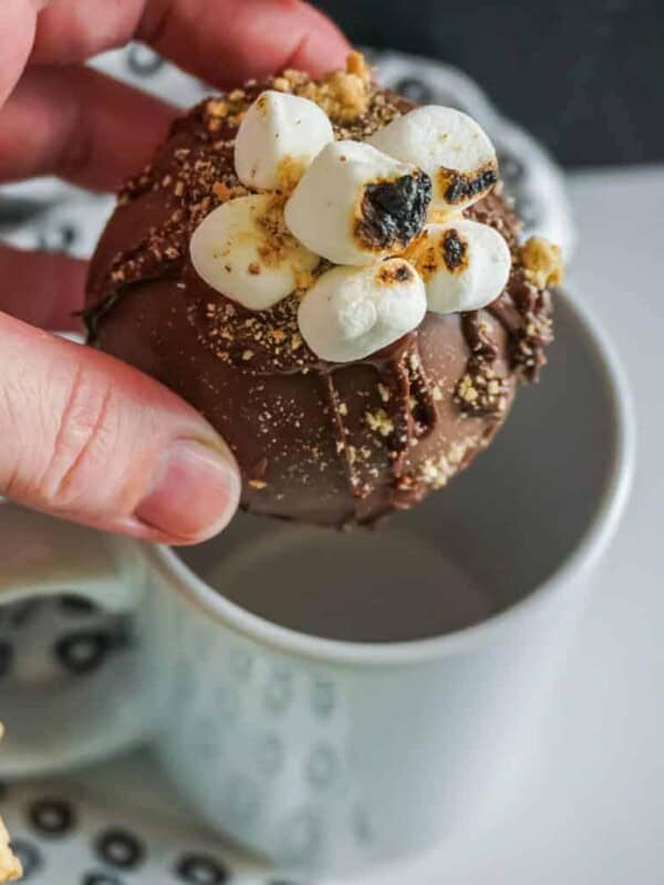 above shot of hot chocolate bomb dropping in to a light blue mug