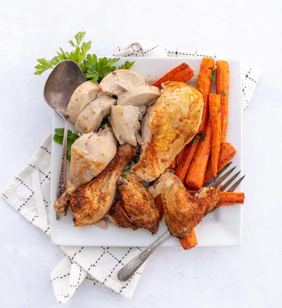 Roasted chicken cut in pieces on white plate