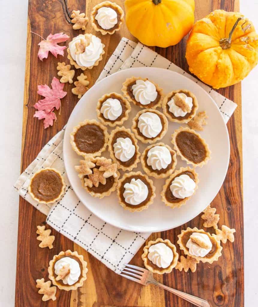 mini pumpkin pie with whipped cream swirl on top