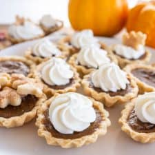 mini pumpkin pie with whipped cream swirl on top