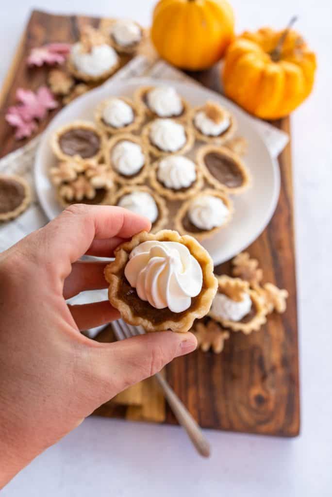 mini pumpkin pie with whipped cream swirl on top