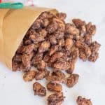 candied almonds spilling out of brown bag