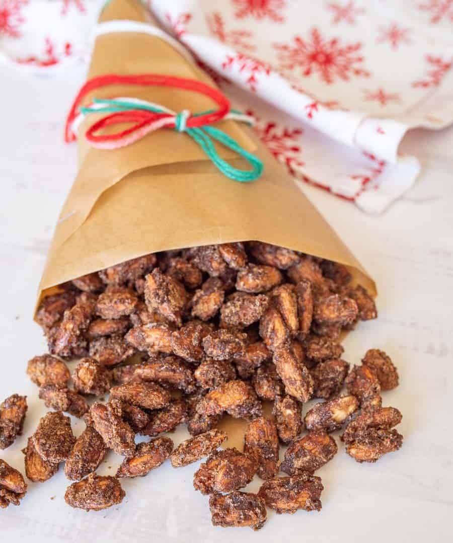 candied almonds spilling out of brown bag