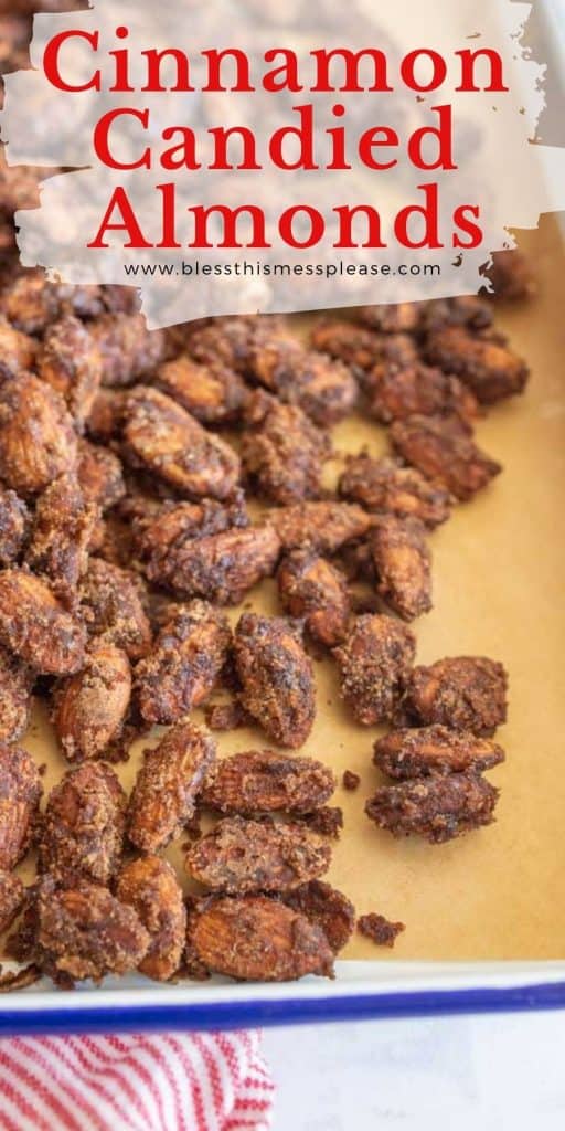 Photo of candied almonds on a baking tray that is lined with parchment paper with "cinnamon candied almonds" written on top