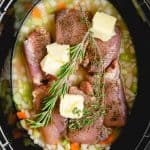 instant pot with the raw ingredients for chicken stew in it and cold butter cubes on top