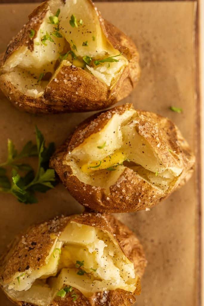 top view of baked potatoes cut open