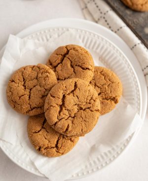 top view of molasses cookies stacked on a plate
