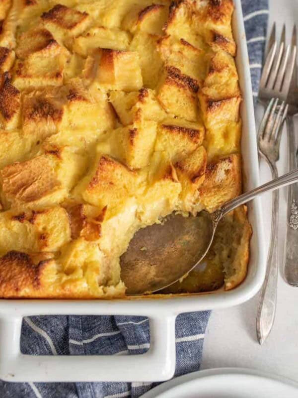 Missing scoop of French toast breakfast casserole out of a dish with a spoon in it