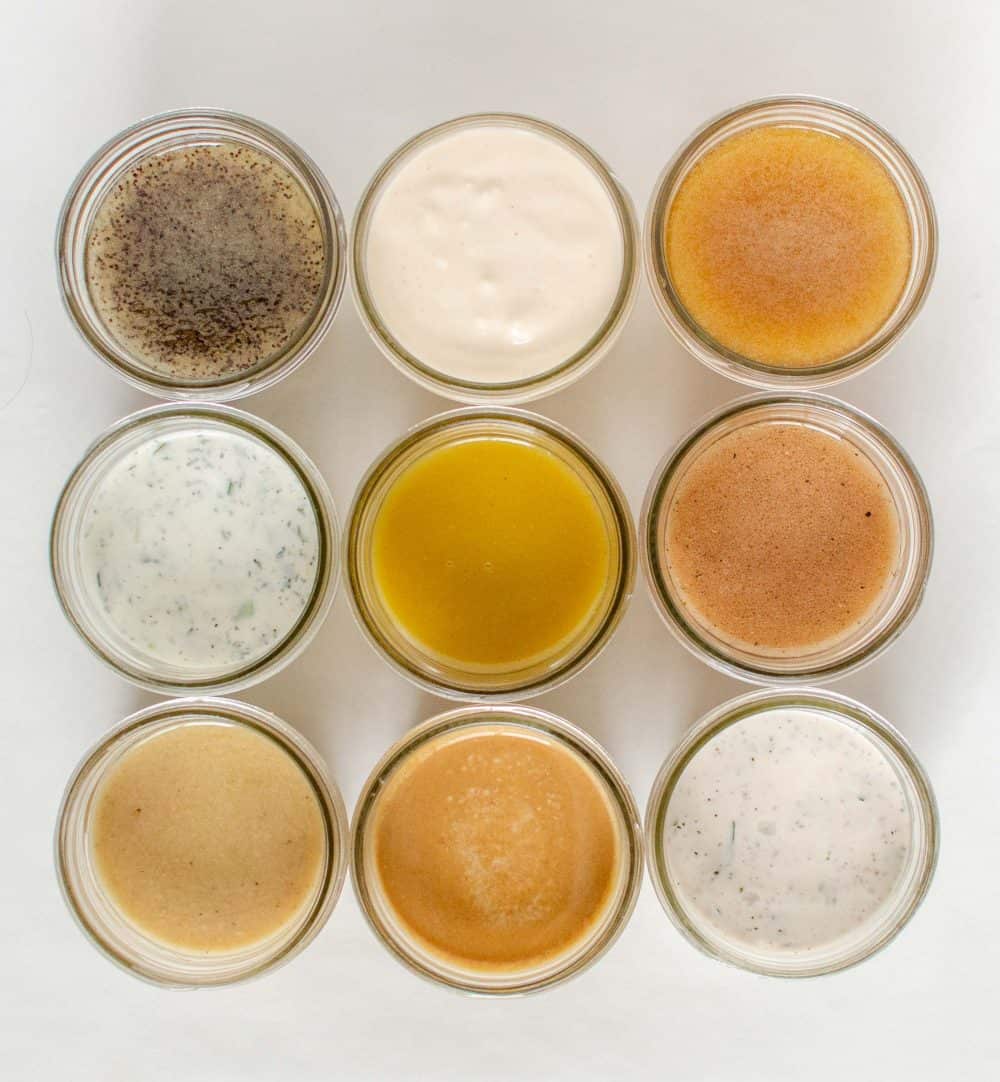 Top view of nine jars of different salad dressings