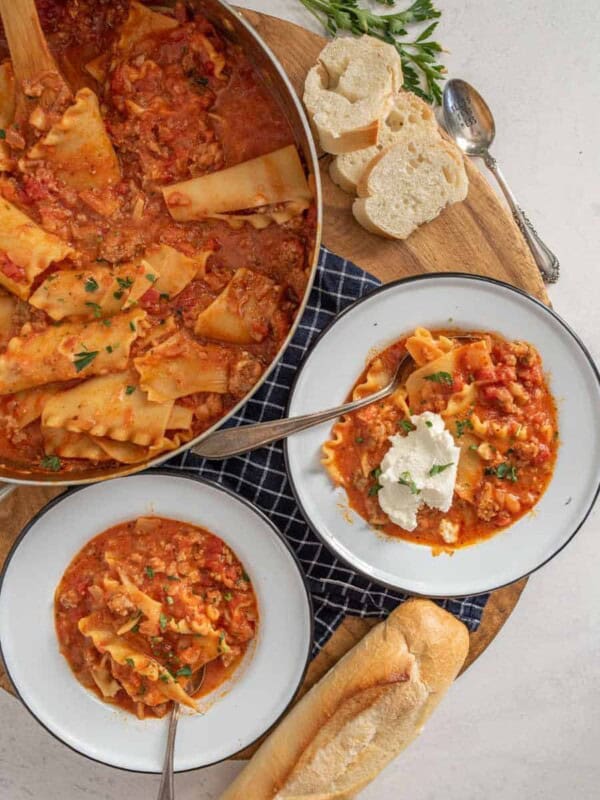 top view of two bowls of lasagna soup next to pot of soup