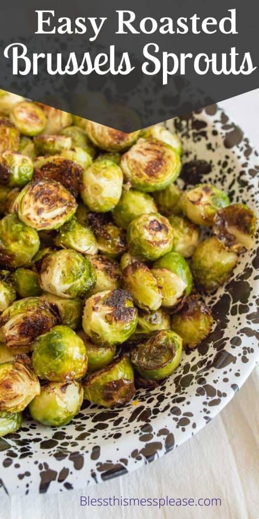Bowl of roasted brussels sprouts with the words "easy roasted brussels sprouts" written at the top
