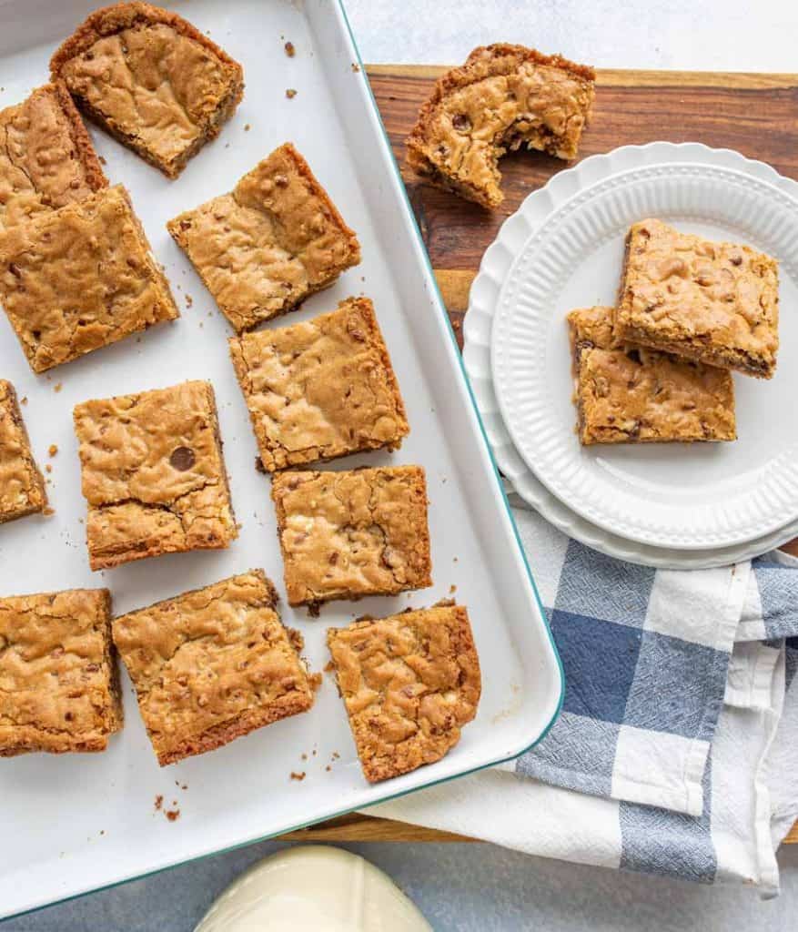 top view of a pan of blondies with a plate of blondies next to it
