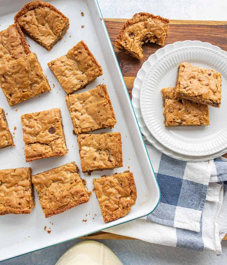 top view of a pan of blondies with a plate of blondies next to it