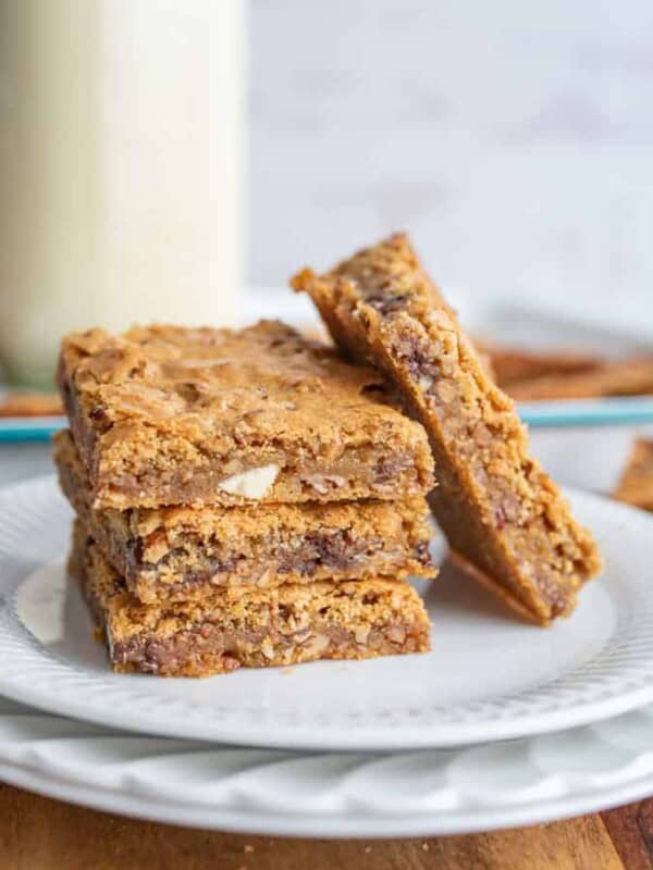 close up of a plate with blondies stacked on each other