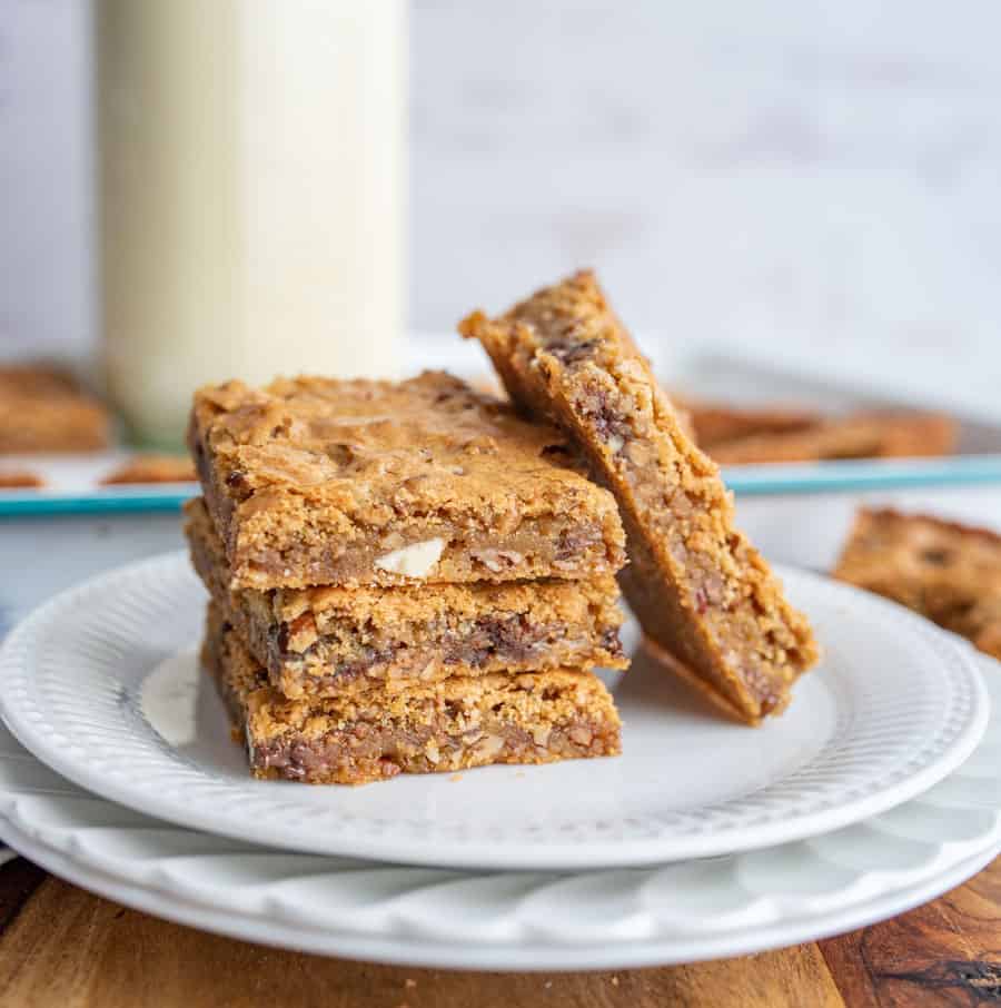 close up of a plate with blondies stacked on each other