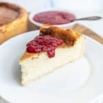 slice of cheesecake topped with raspberry sauce on a plate