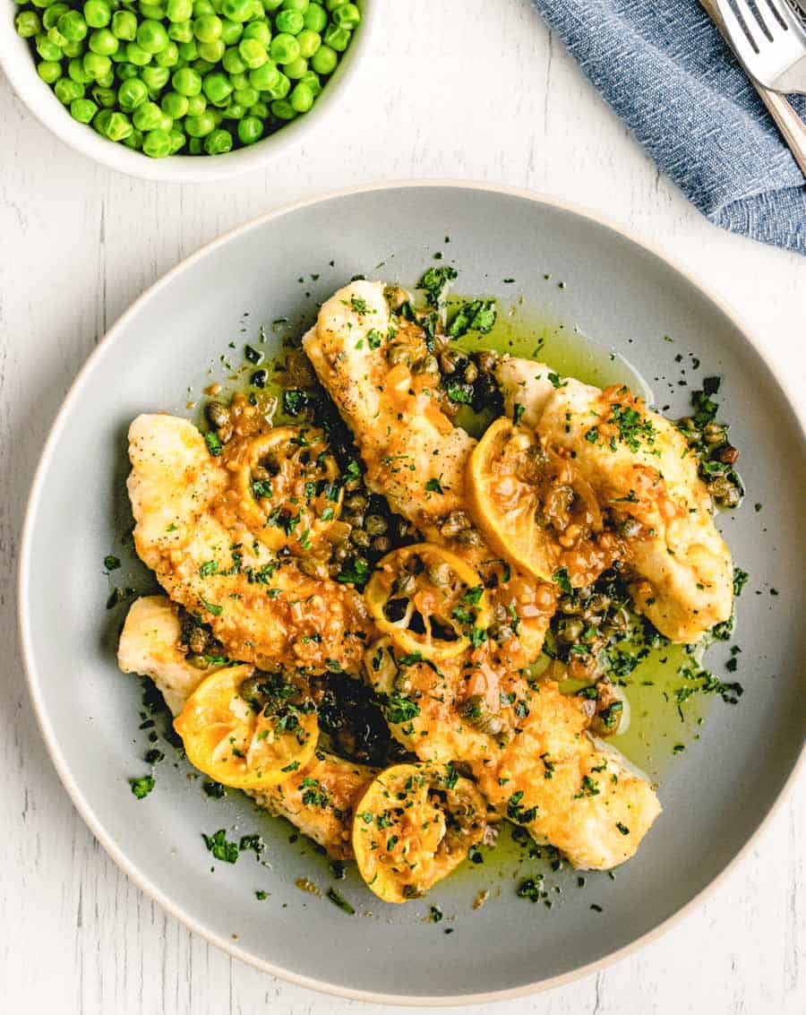 top view of a plate of chicken picatta with lemon slices