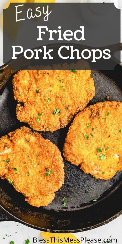 top view of three crispy fried pork chops in a cast iron skillet with the words "easy fried pork chops" written at the top