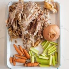 picture of the ingredients for chicken broth spread out on a baking sheet