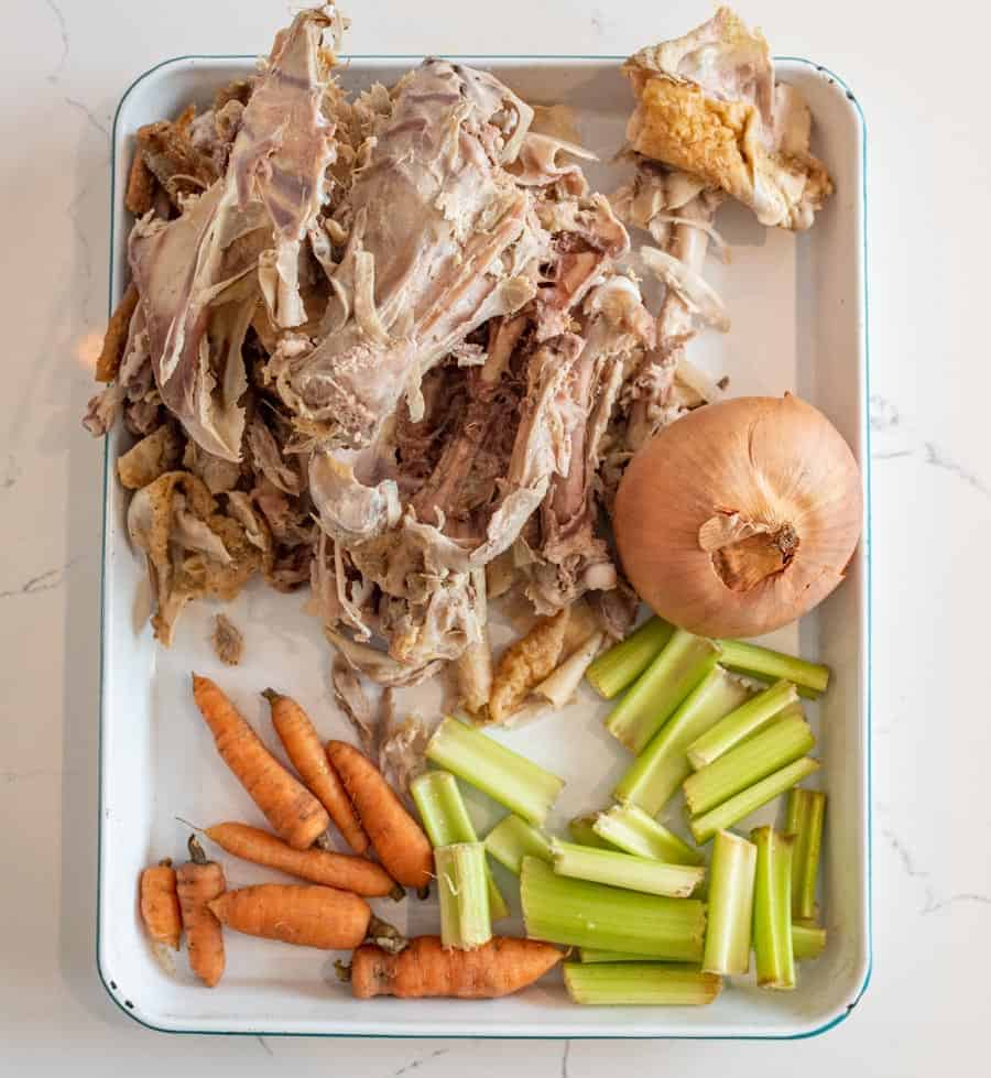 picture of the ingredients for chicken broth spread out on a baking sheet