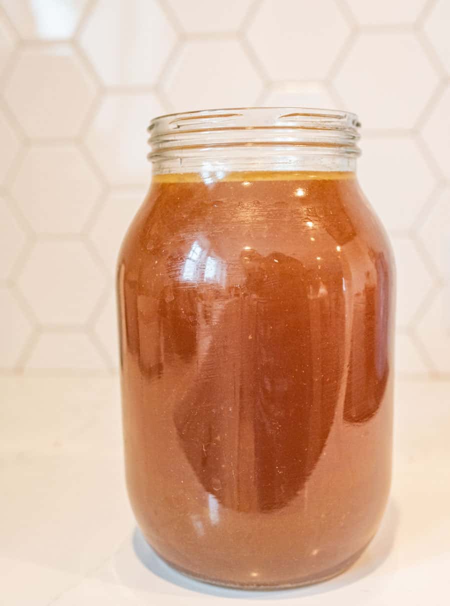 Picture of a glass jar filled with chicken broth