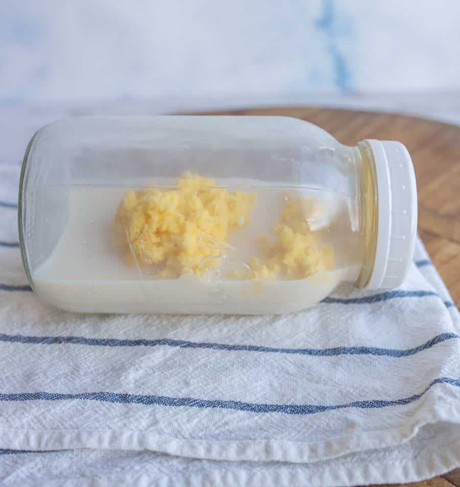 mason jar on its side with buttermilk and butter inside