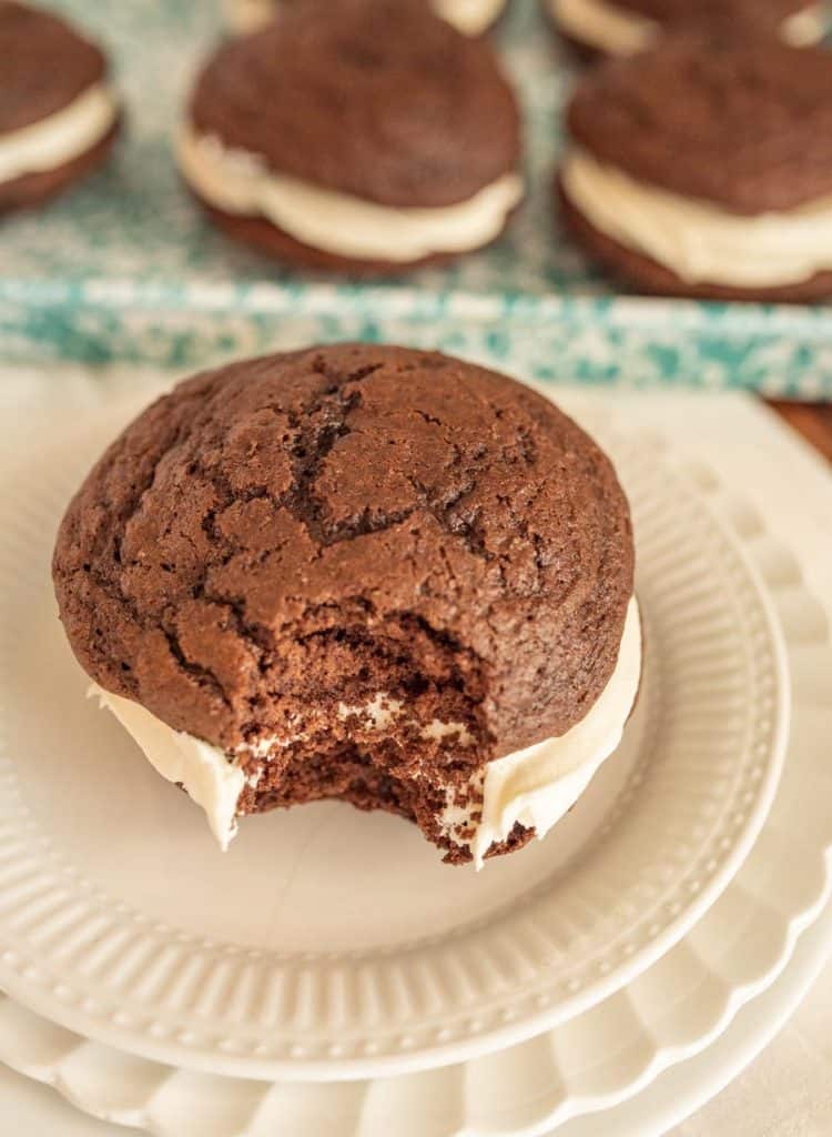 close up of a whoopie pie with a bite taken out of it on a plate