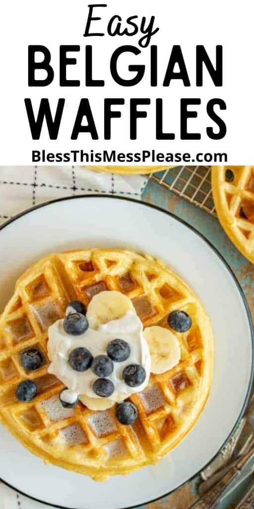 Top view of a waffle on a plate, topped with blueberries, banana slices, and whipped cream, with the words "easy Belgian waffles" written at the top